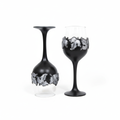 Black wine glasses with silver ornaments on white background
