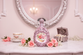 Romantic pink floral bottle in elegant lifestyle setting