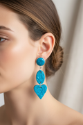 Polymer clay earrings worn on ear