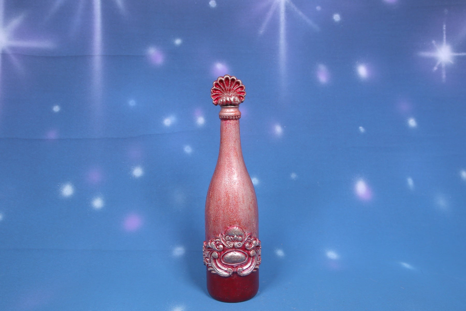 Decorated wine bottle with pink cracks and baroque ornaments