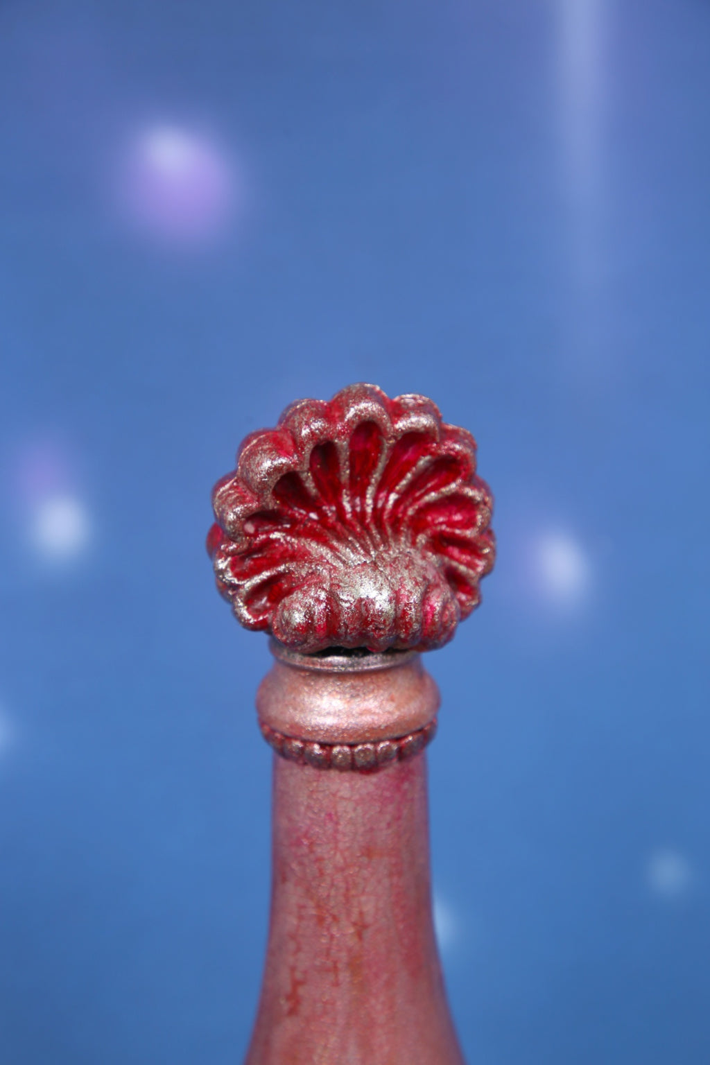 Decorated wine bottle with pink cracks and baroque ornaments